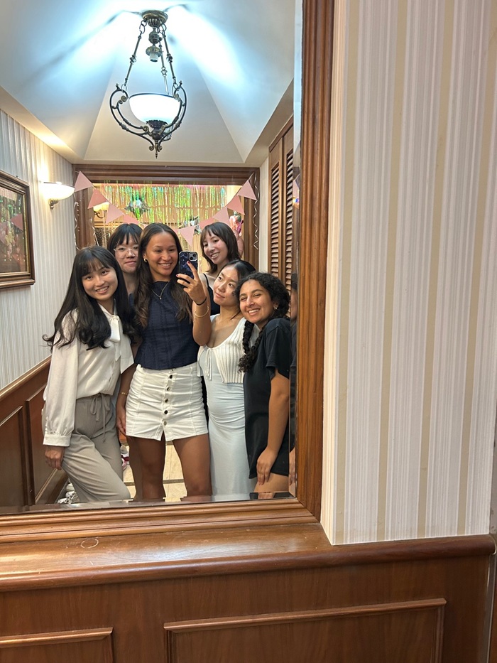 A group selfie of CET Taiwan roommates in a mirror