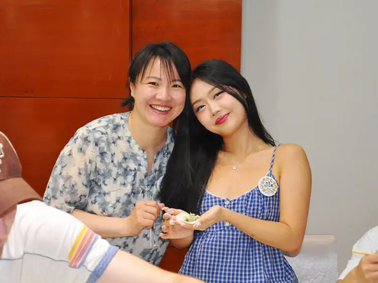 students holding dumplings