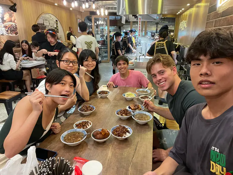 students and roommates eating dinner