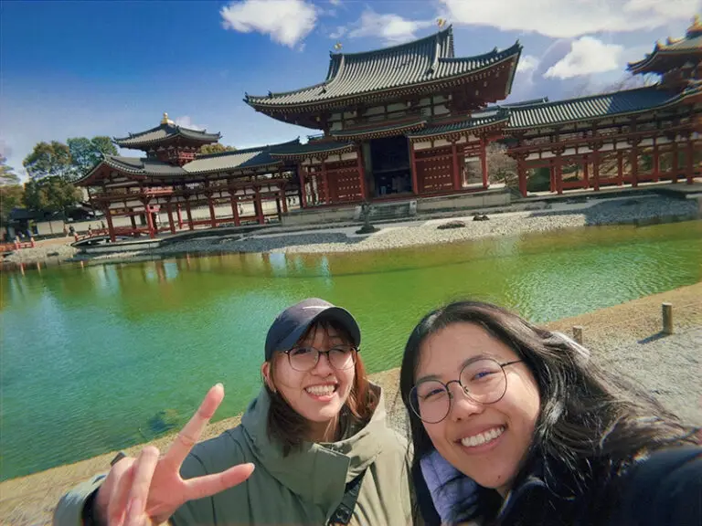 students taking selfie in front of temple