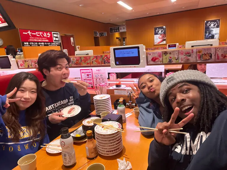 students eating sushi at table