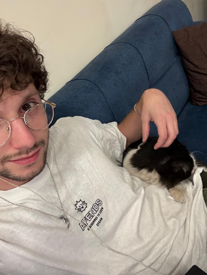 A CET Jordan sitting with a cat on a couch