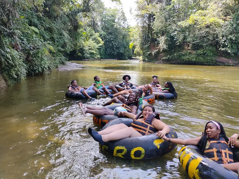 students floating in tubes on river