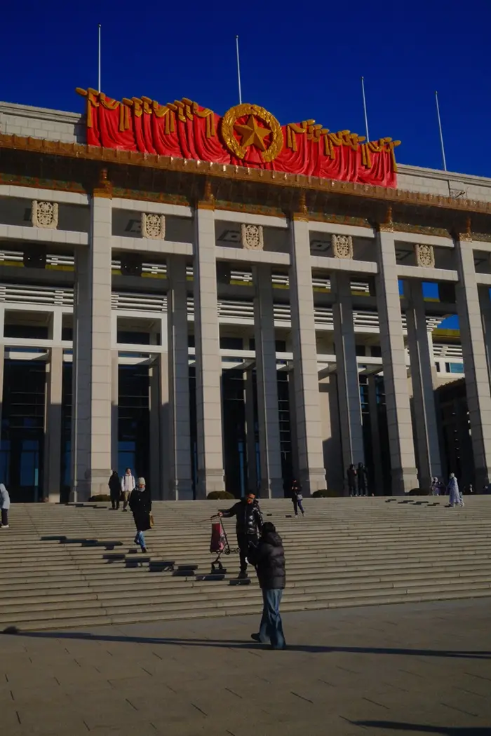 People walking down the stairs in front of the National Museum of China