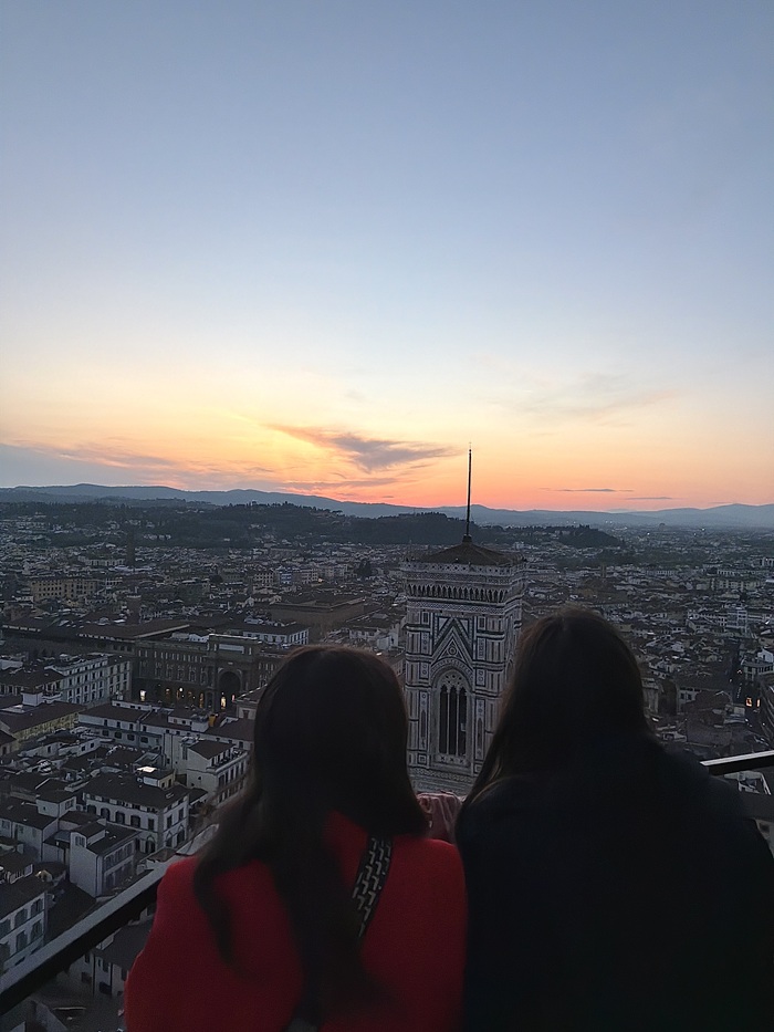 Two female CET Florence students overlooking the city during sunset from the top of the Duomo