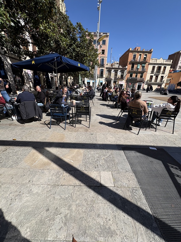 People sitting at tables outside in Plaça de Sant Martí