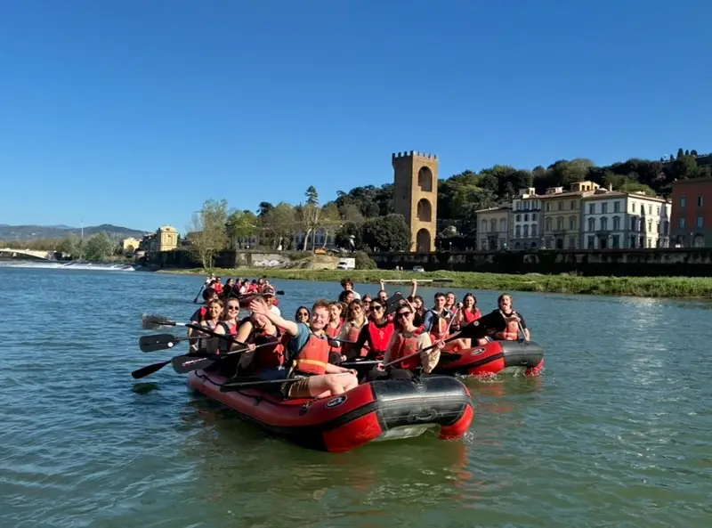 A group of CET Florence students on boat rafts while on the Arno River in Florence, Italy