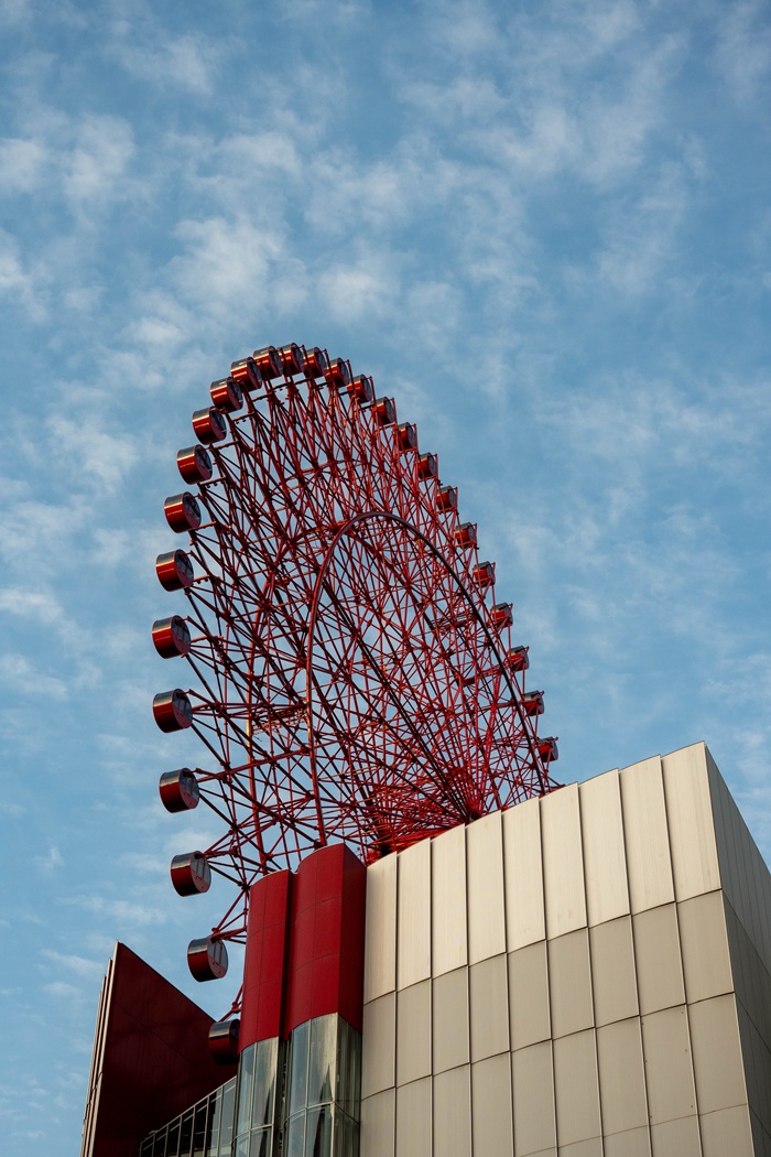 The HEP Five Ferris wheel, a iconic red structure integrated onto the roof of a shopping mall in Osaka, Japan.