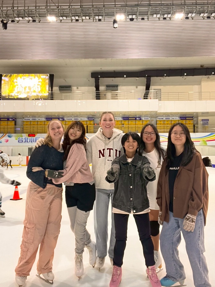 A group of CET Taiwan students and local roommates posing on an ice skating rink together