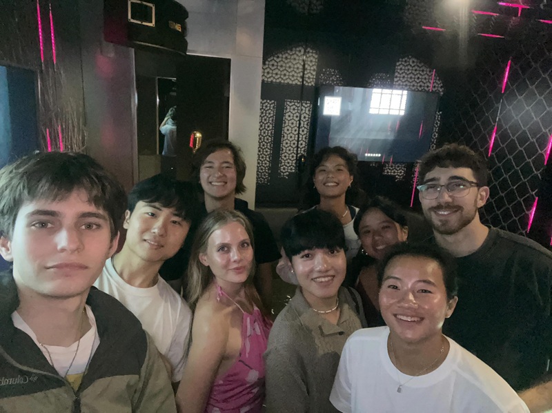 A group of CET Taiwan students and local roommates smiling while inside of a karaoke room in Taipei.
