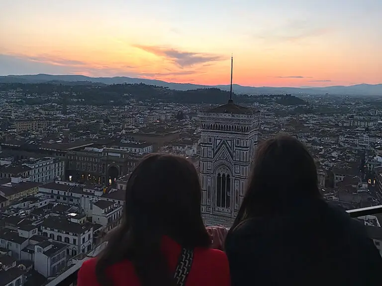students looking at view of Florence from the top of the Duomo at sunset