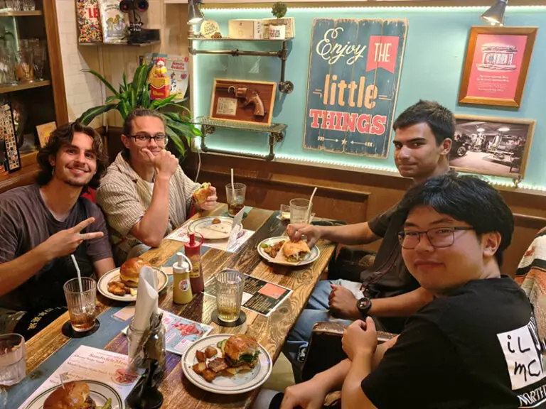 students and roommates at dinner table