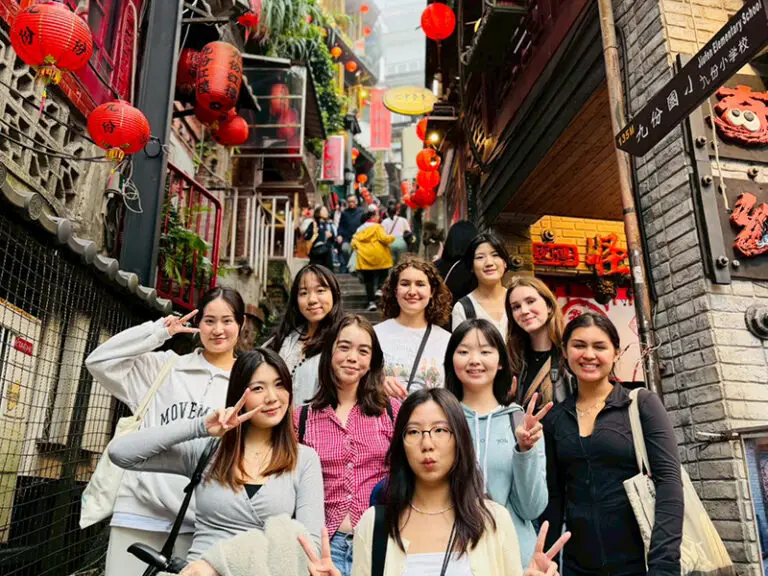 students posing for photo in street