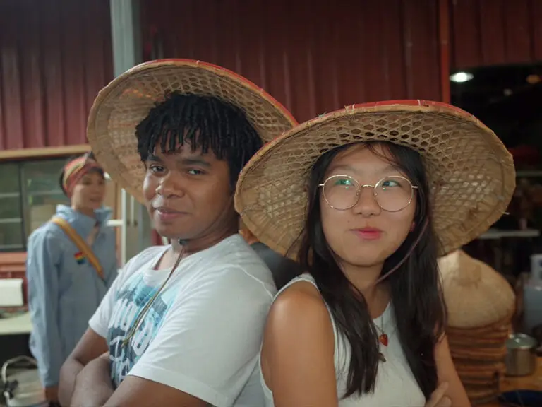 students at tea farm with hats on