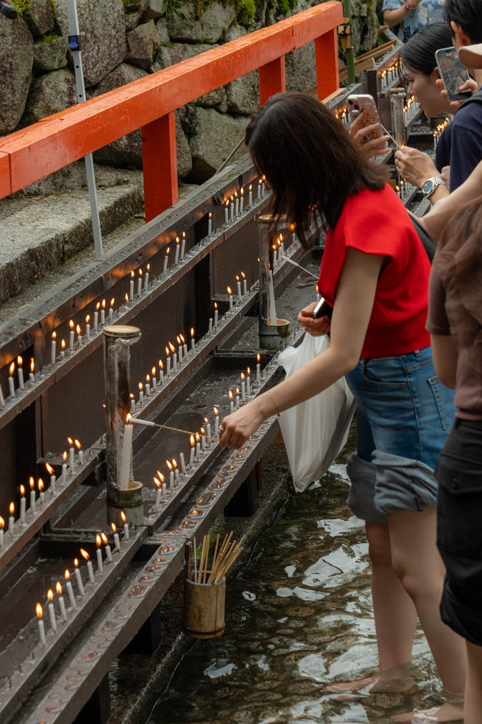 People lighting a candle at the Mitarashi Matsuri in Japan