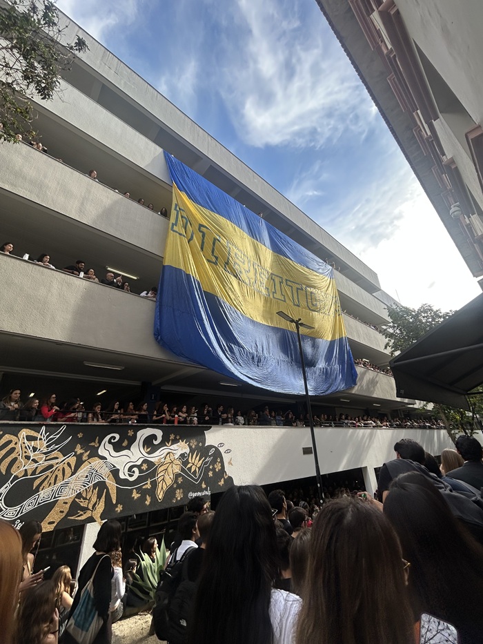 A banner hanging from a building within Pontifícia Universidade Católica de São Paulo's campus