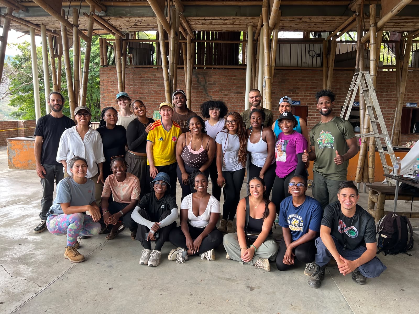 Group posing together inside a bamboo structure.