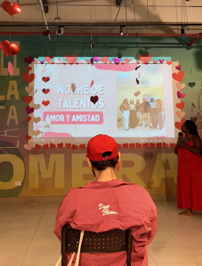 Talent show presentation decorated with hanging hearts.