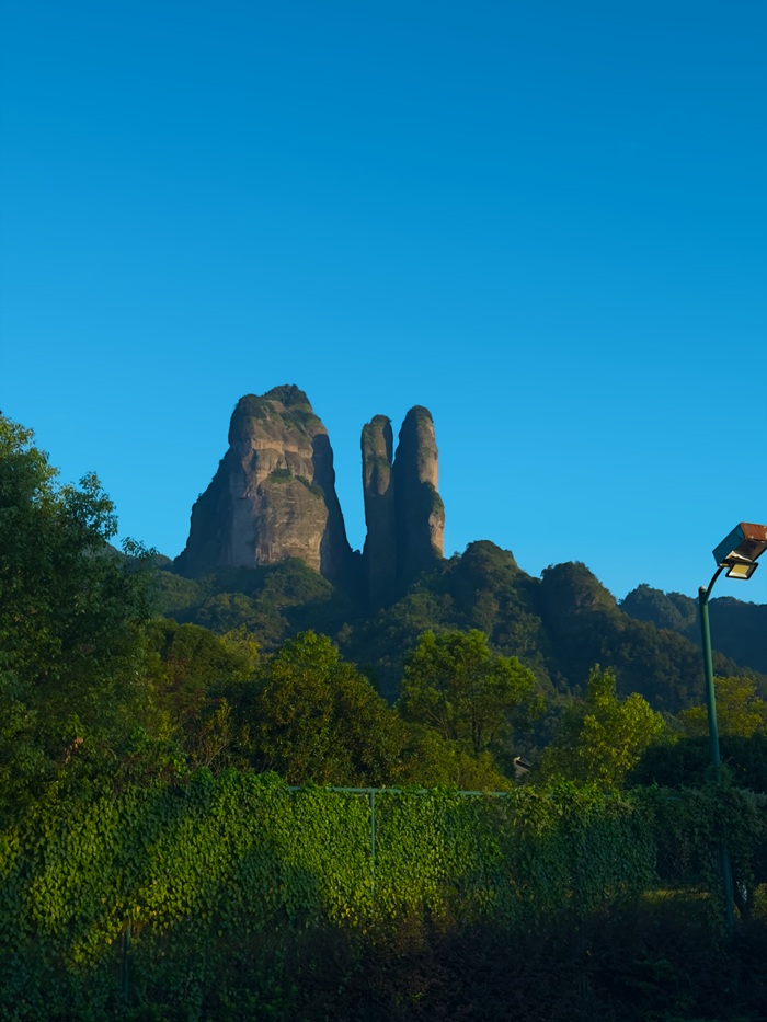 Tall rock formations surrounded by green mountains