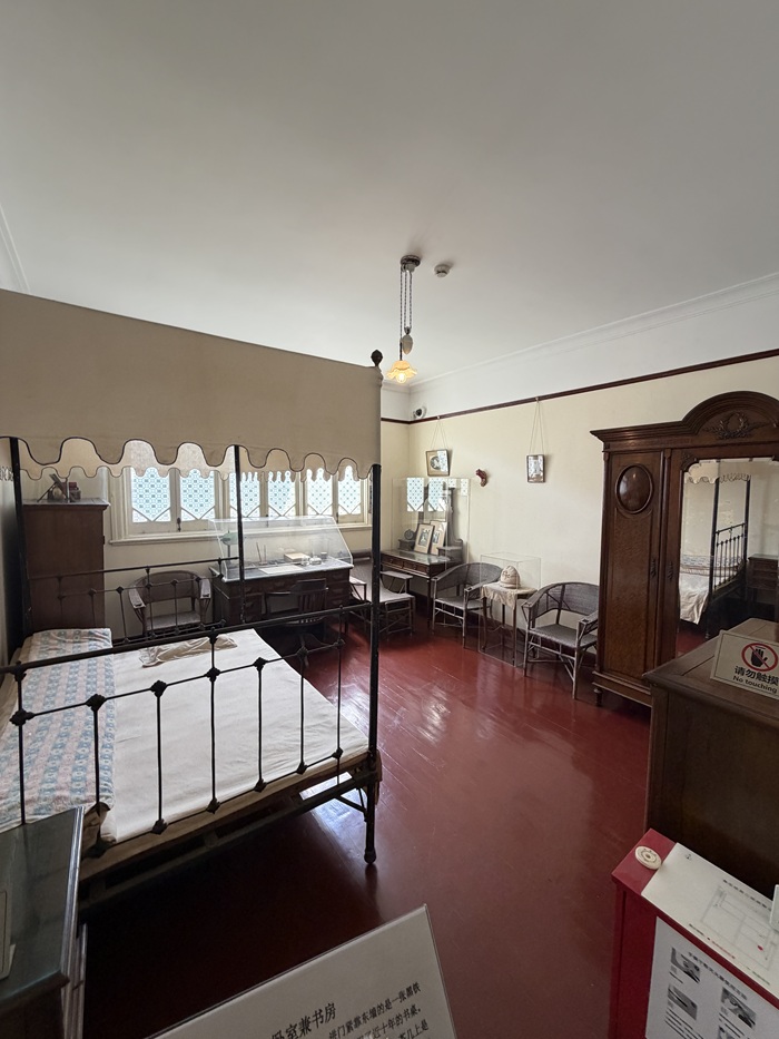 Historic bedroom with antique furniture and red flooring